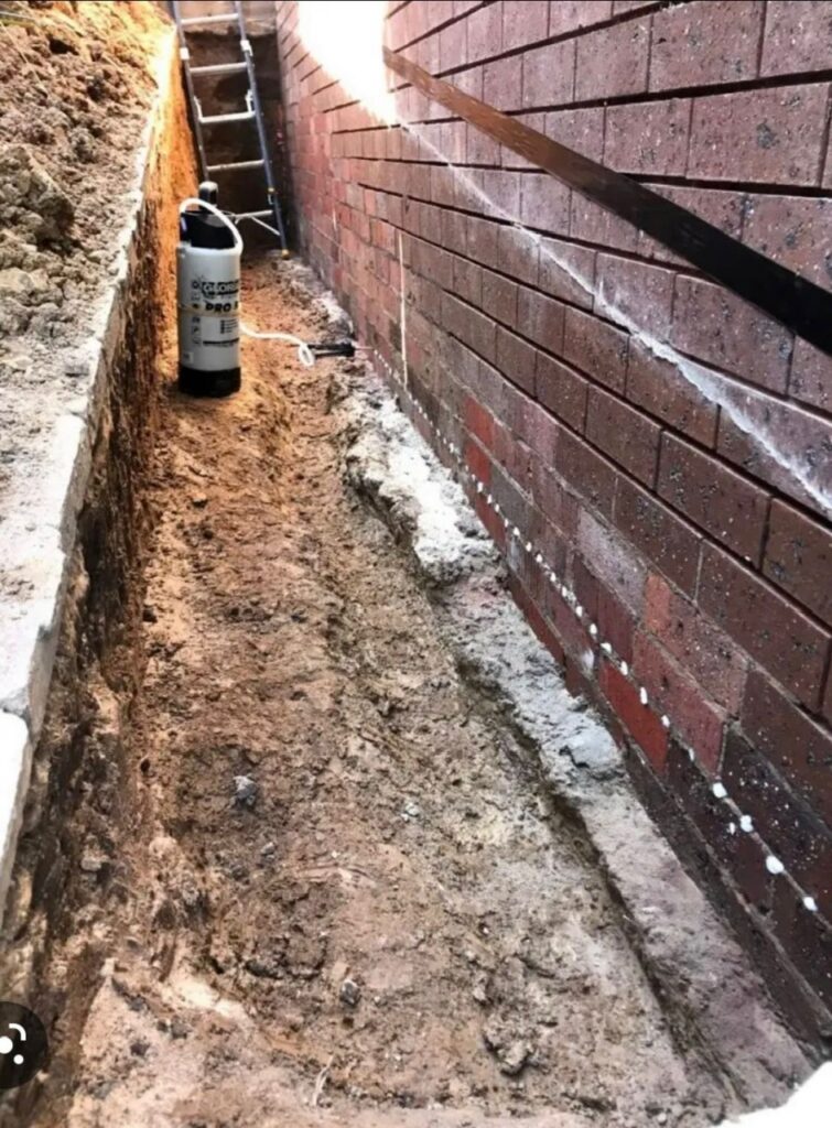 Exterior waterproofing applied to a brick foundation in Greater Boston.