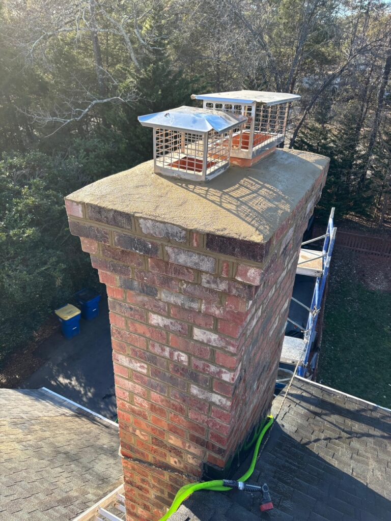 Finished brick chimney with a sound crown and caps after a chimney restoration.