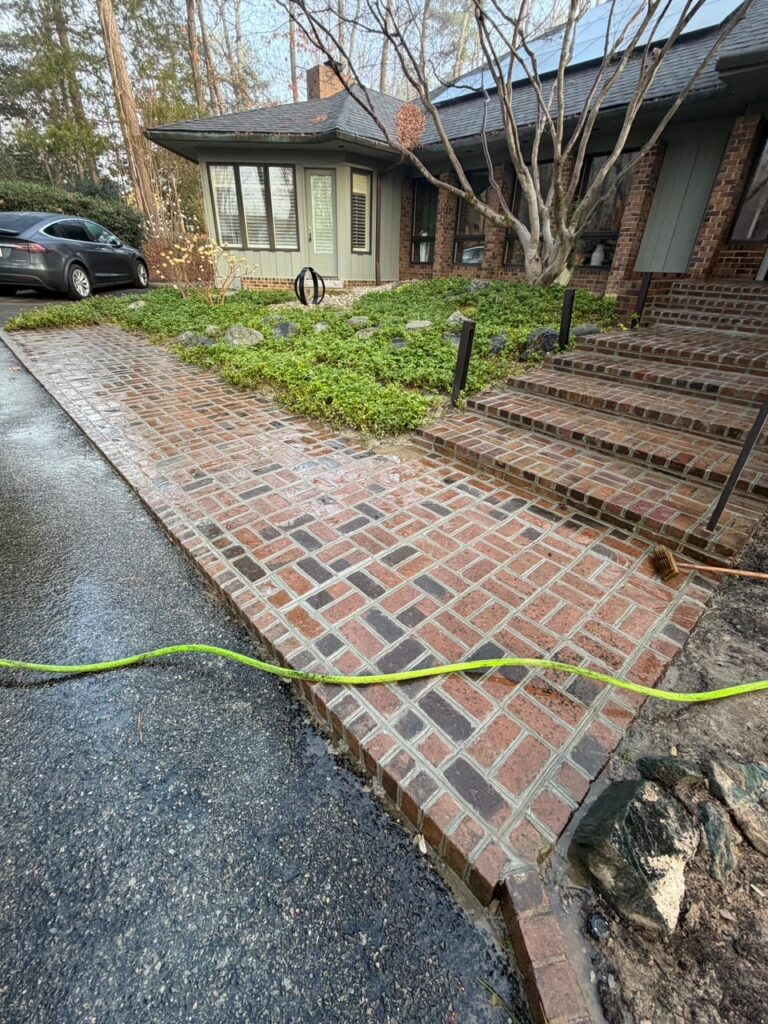 A finished brick walkway and steps at the entrance of a Greater Boston home