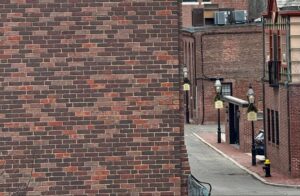 Older brick buildings along a Greater Boston street where repointing old brick is common.