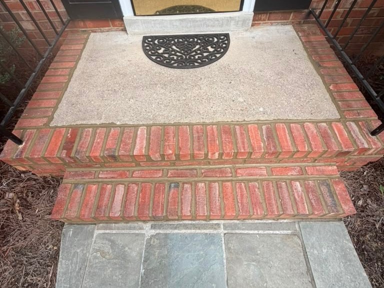 Rebuilt brick front steps and bluestone walkway at a home in Cambridge, MA.