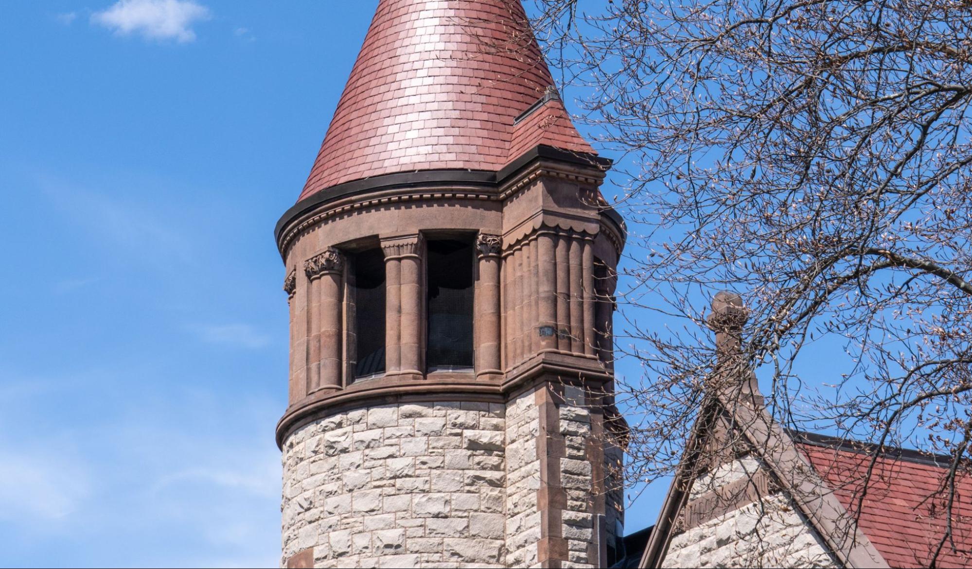Rough-cut stone and brownstone tower showing the kind of masonry work a Cambridge, MA masonry contractor restores.