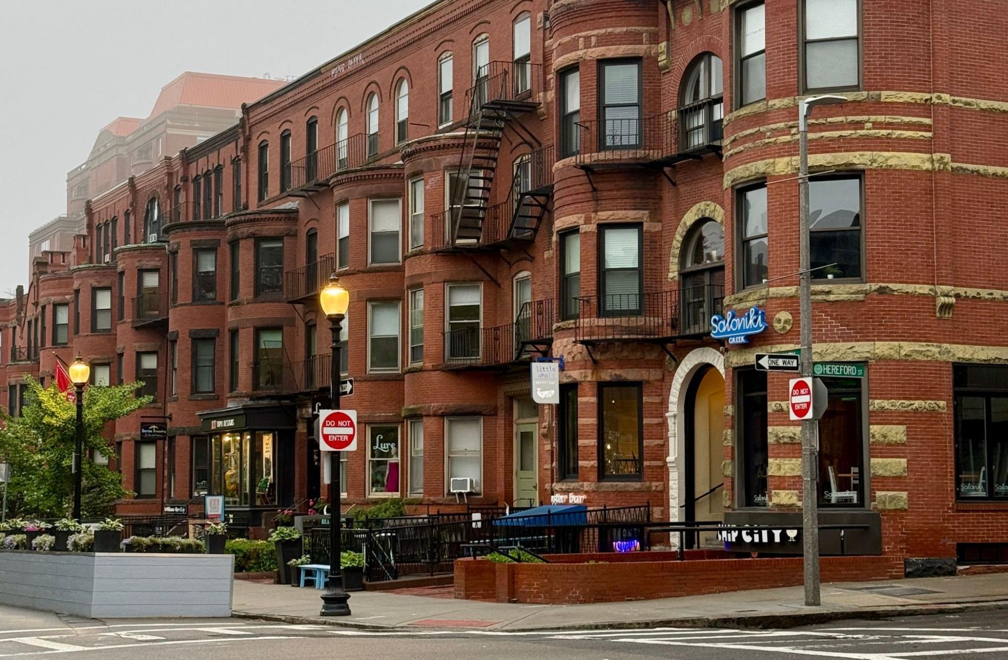 Brick rowhouses on a Quincy, MA street served by masonry contractor Three Hills Masonry.